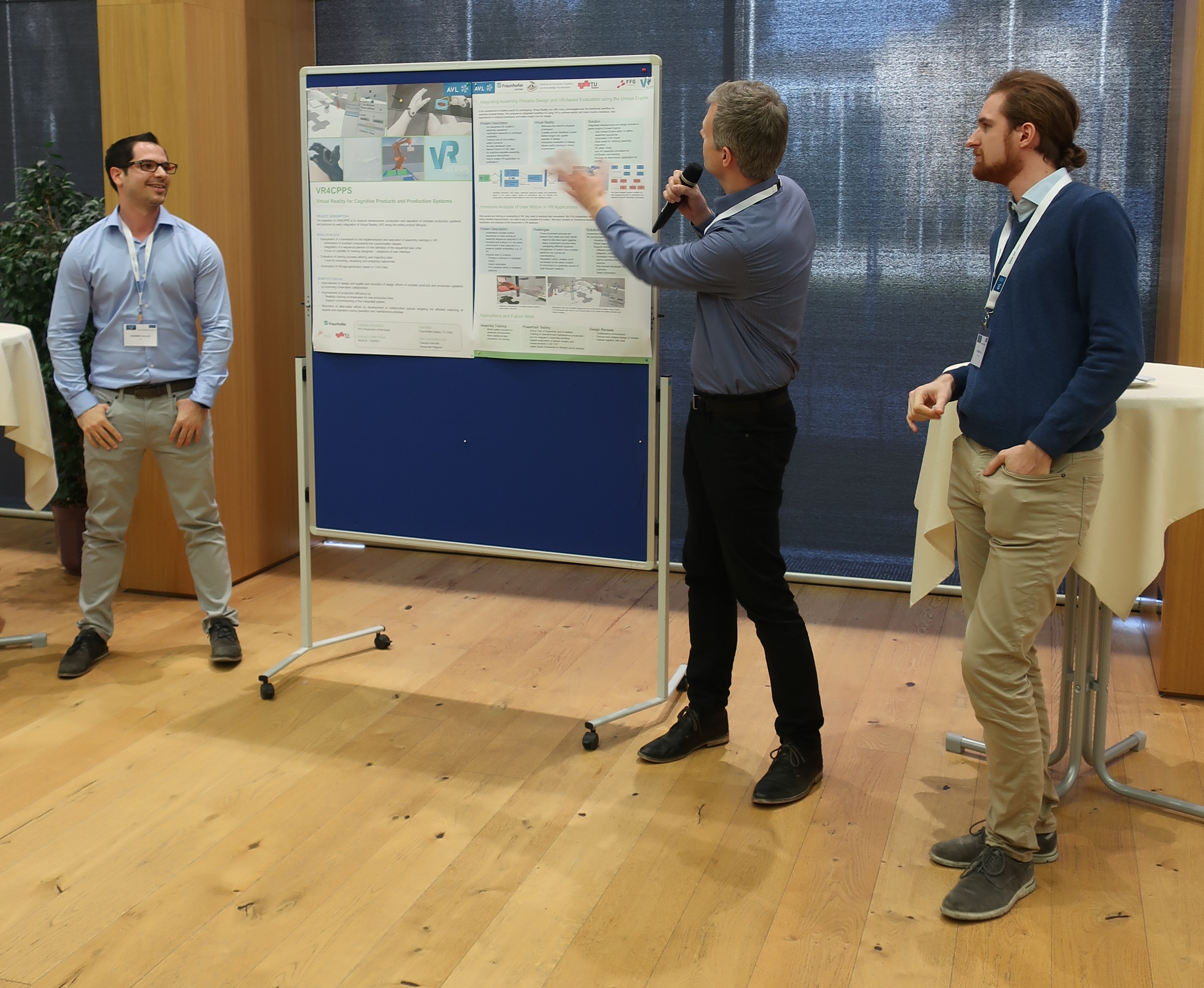 An image of representatives of the three parties involved with the project presenting our poster at the AVL networking day.